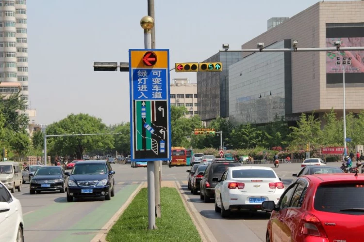 a road with cars and trafic light for reverse variable turn lane