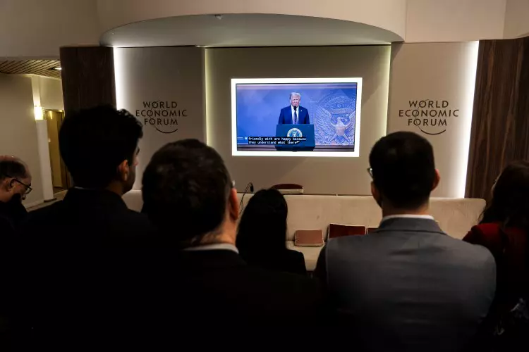participants of the World Economic Forum 2025 are watching Trump's speech