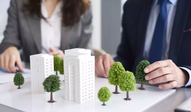 Shot of architectural model on the table in the office: affordable urban housing solutions