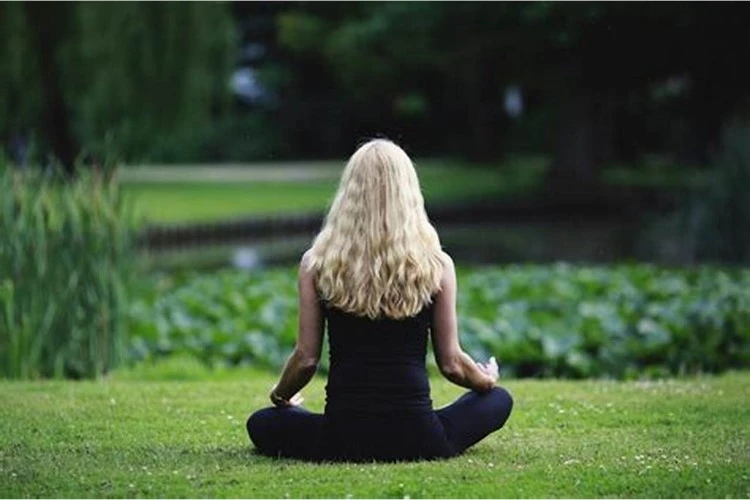 A woman meditating in the park